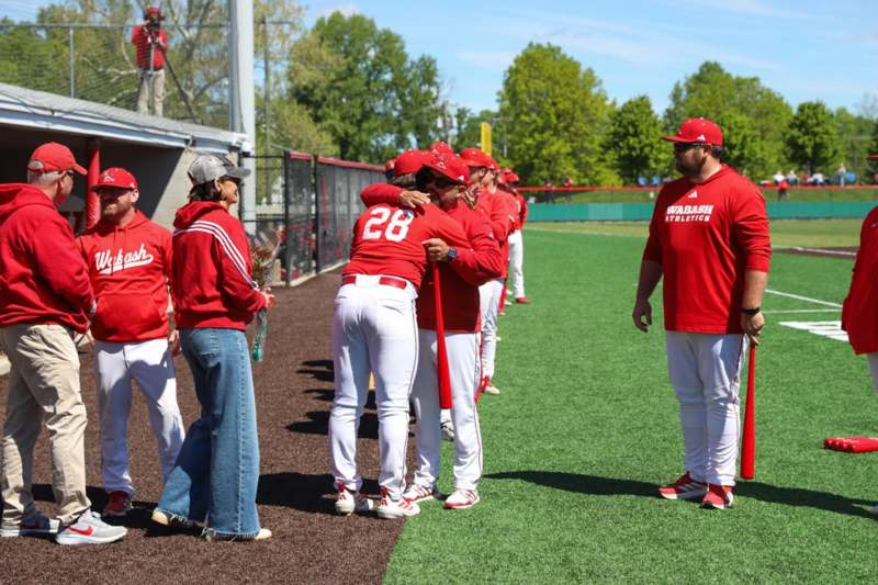 a group of people in red shirts and white pants on a field