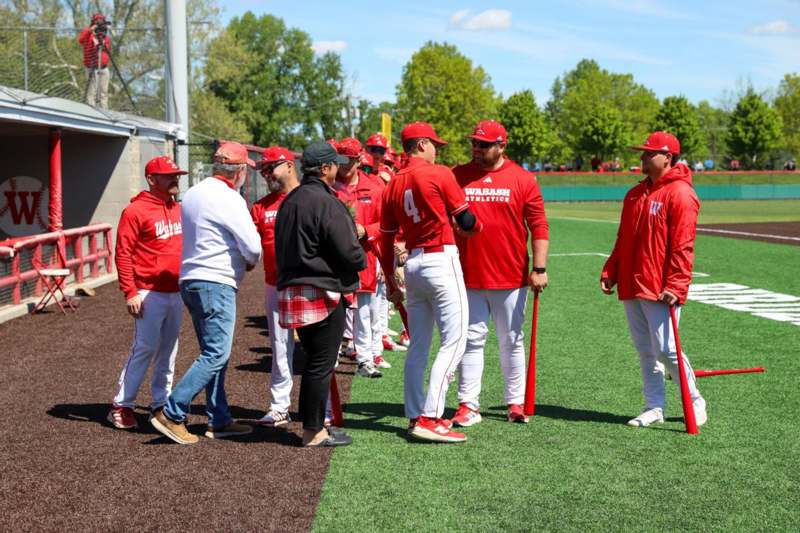 a group of men in red uniforms on a field