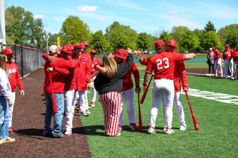 a group of people in red uniforms on a field