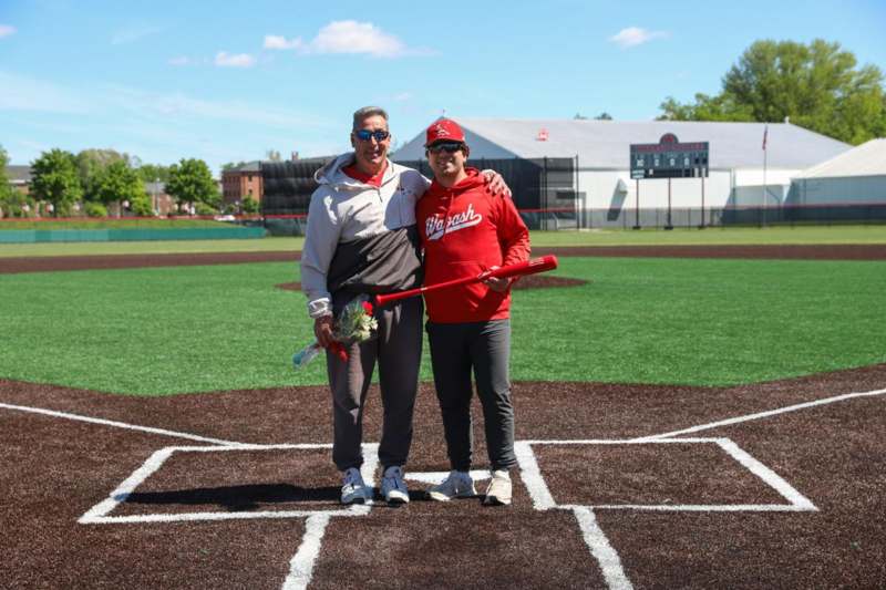 two people standing on a baseball field