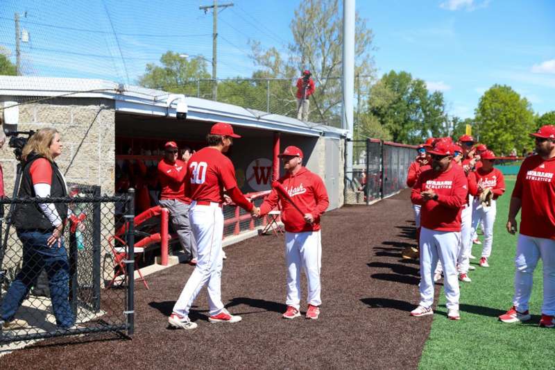 a group of baseball players shaking hands
