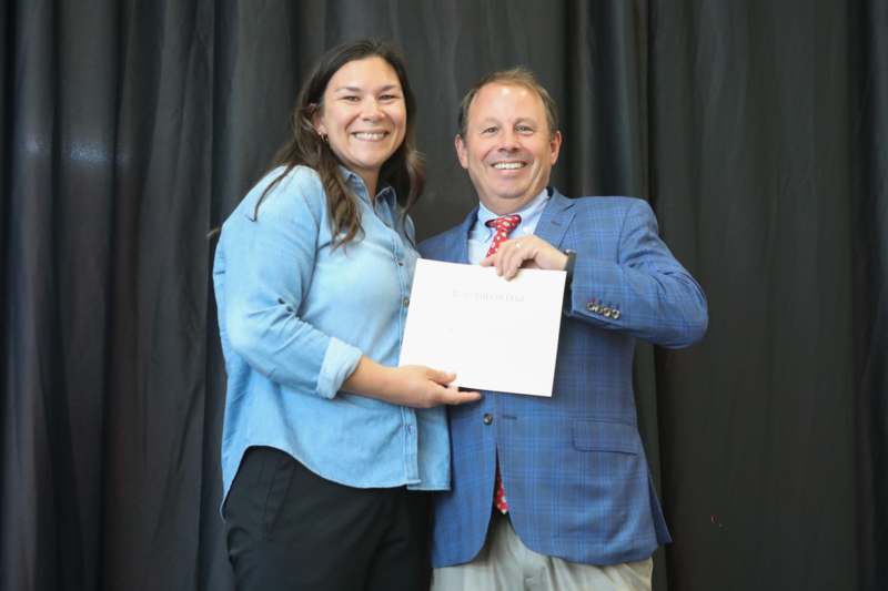 a man and woman holding a piece of paper