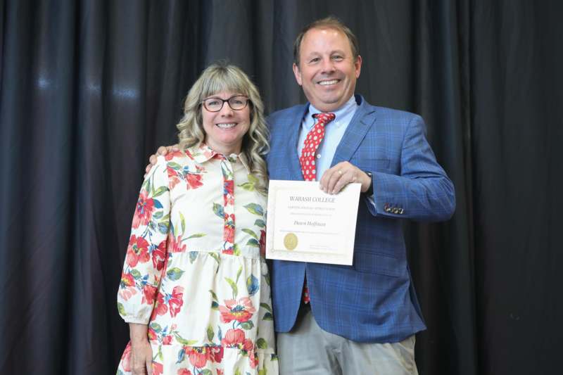 a man and woman holding a certificate