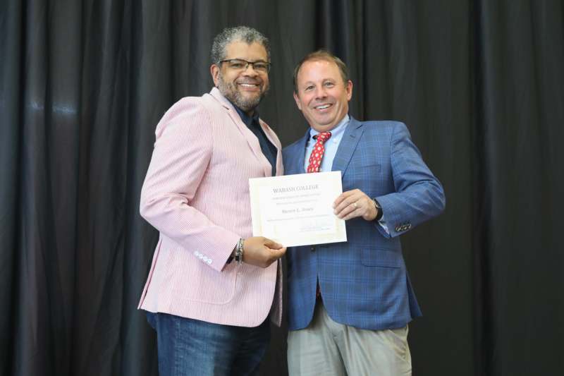 two men holding a certificate