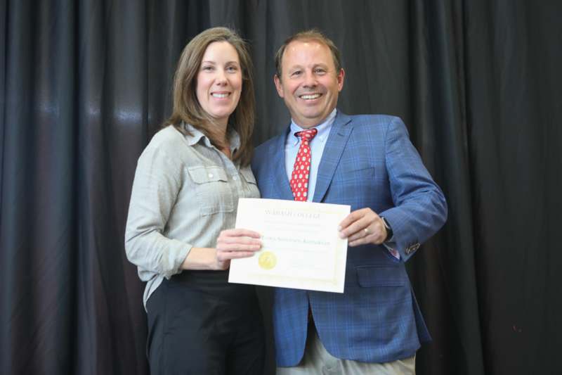 a man and woman holding a certificate