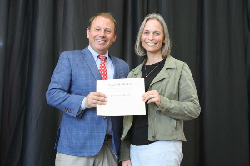 a man and woman holding a certificate