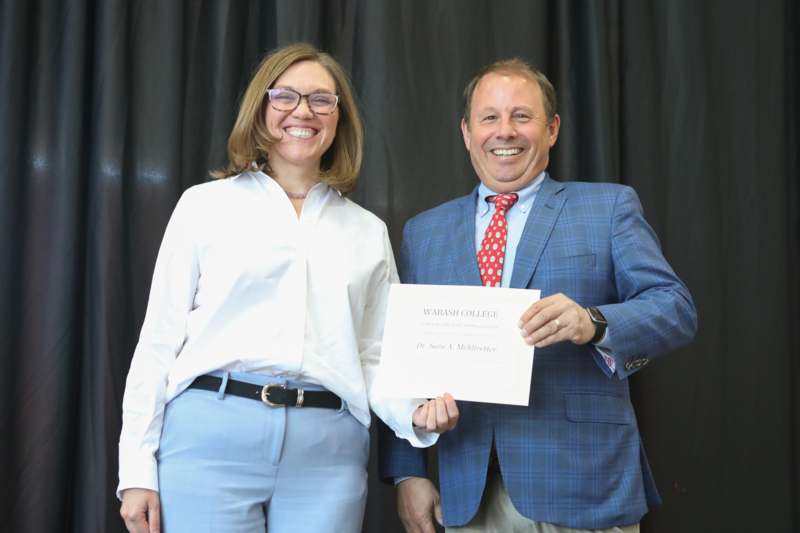 a man and woman holding a certificate