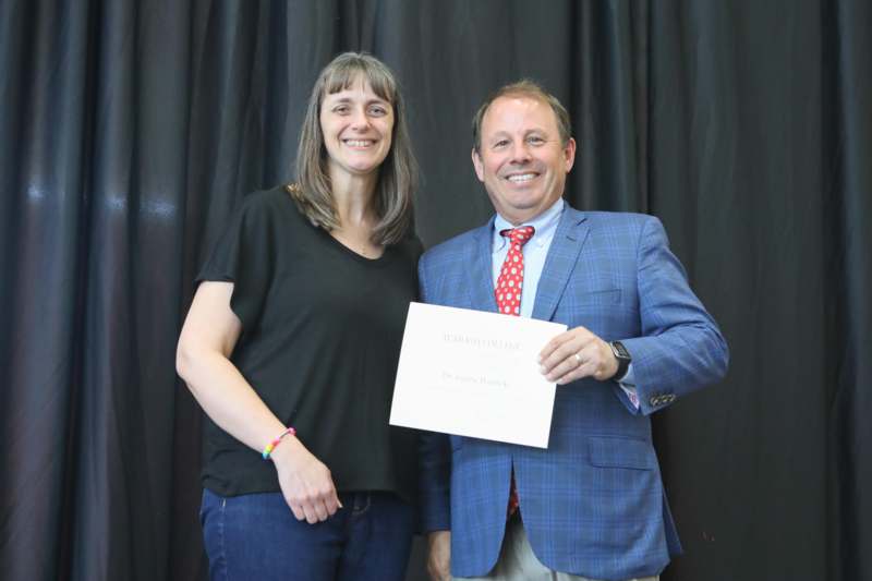 a man and woman holding a certificate