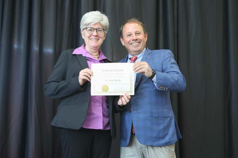 a man and woman holding a certificate