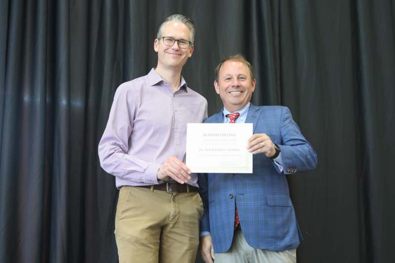 two men holding a certificate