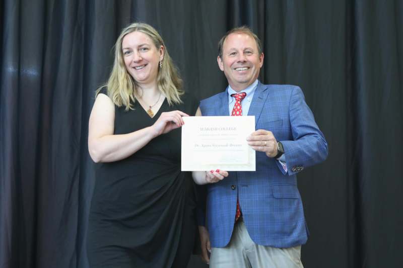 a man and woman holding a certificate