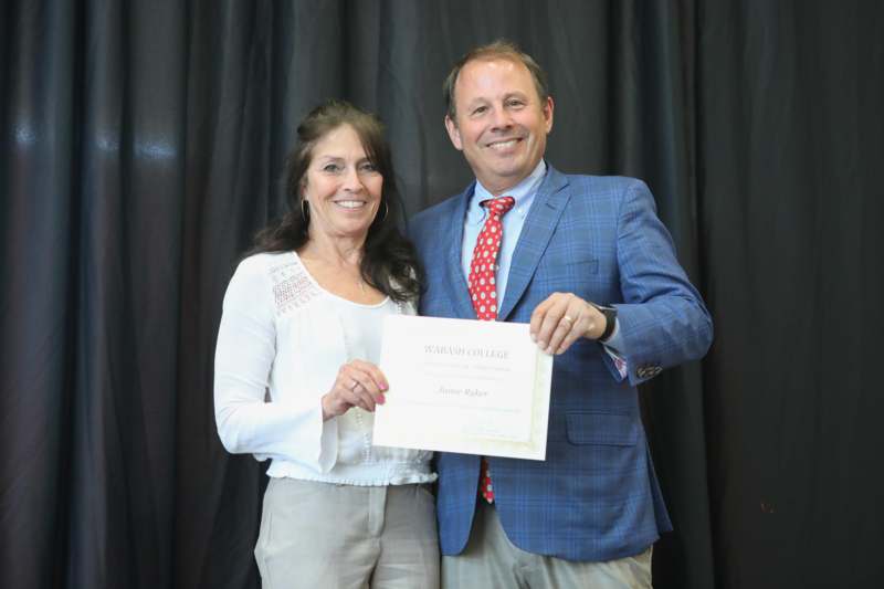 a man and woman holding a certificate