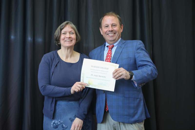 a man and woman holding a certificate