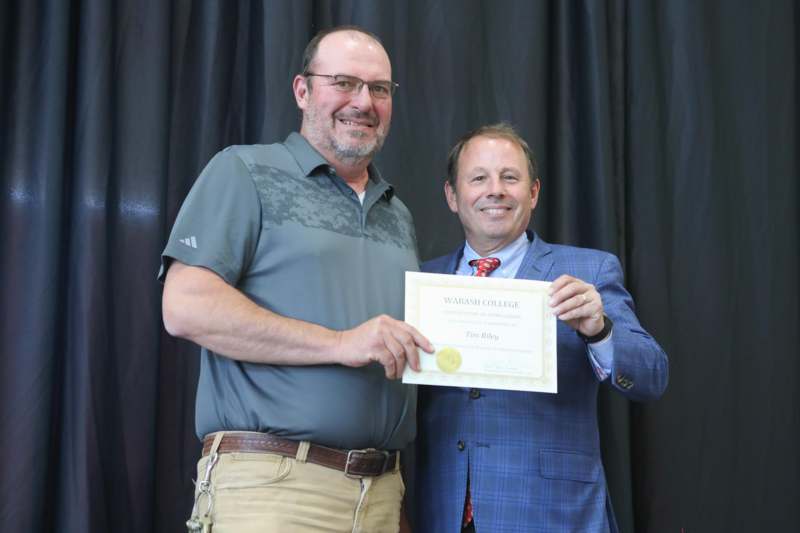 two men holding a certificate