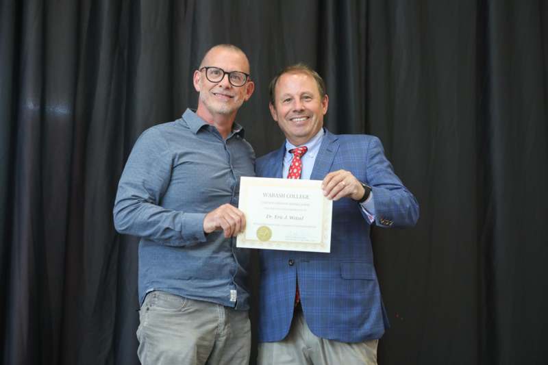 two men holding a certificate