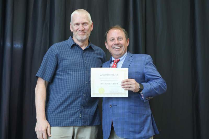 two men holding a certificate