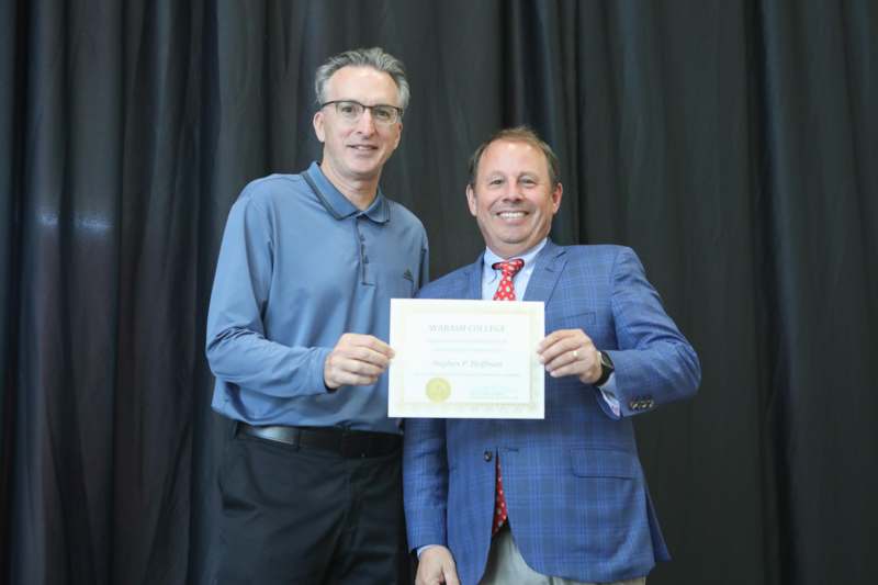 two men holding a certificate