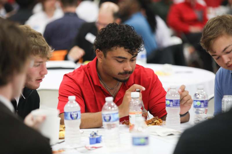 a group of people sitting at tables eating food