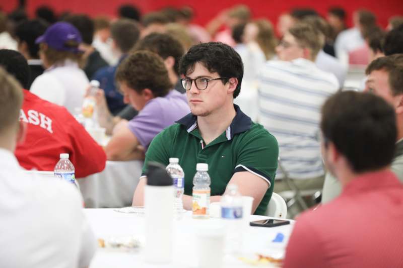 a man sitting at a table with other people