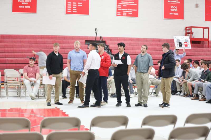 a group of people standing in a gym