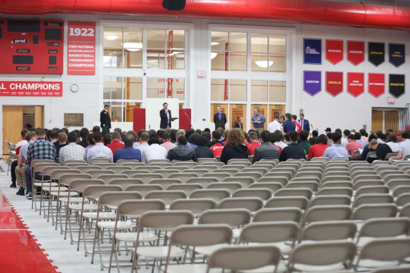 a group of people in a room with chairs