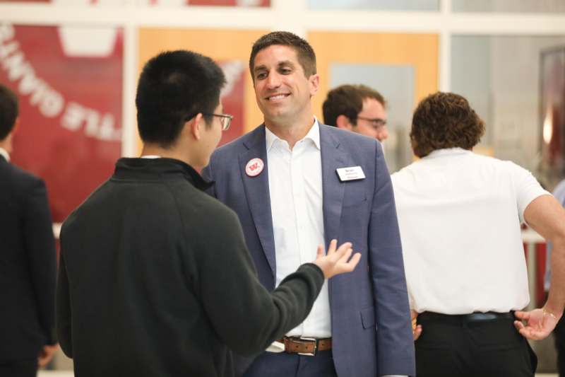 a man in a suit talking to another man
