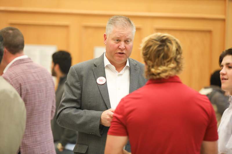 a man in a suit talking to a woman