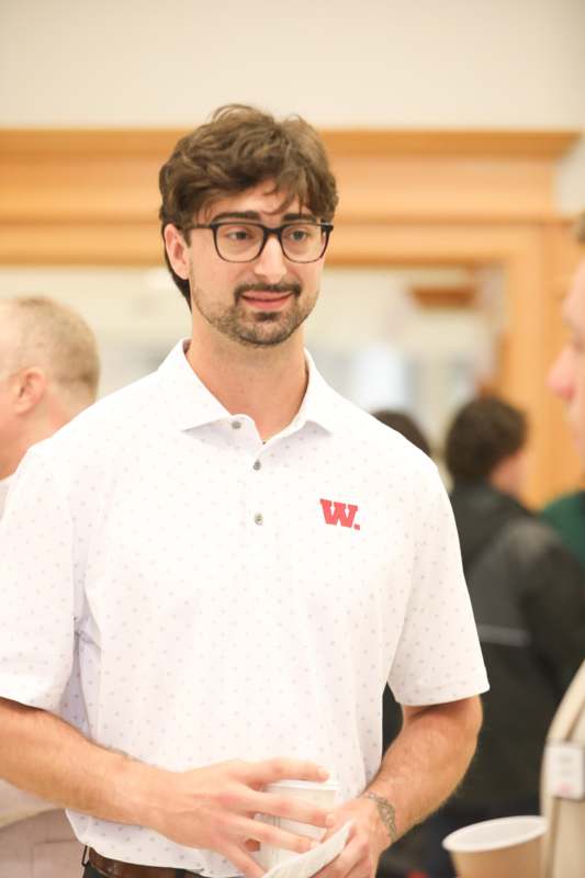 a man wearing glasses and a white shirt