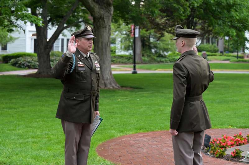 a man in uniform saluting another man in uniform