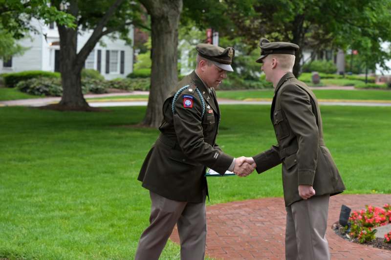 a man in uniform shaking hands with another man in uniform