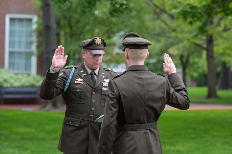 two men in military uniforms saluting