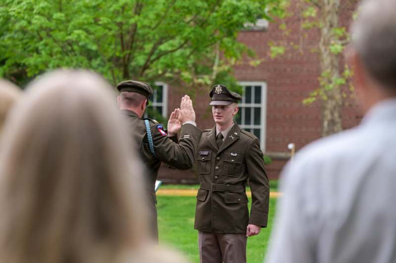 a man in uniform giving a high five to another man