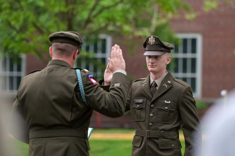 a man in uniform giving a high five to another man