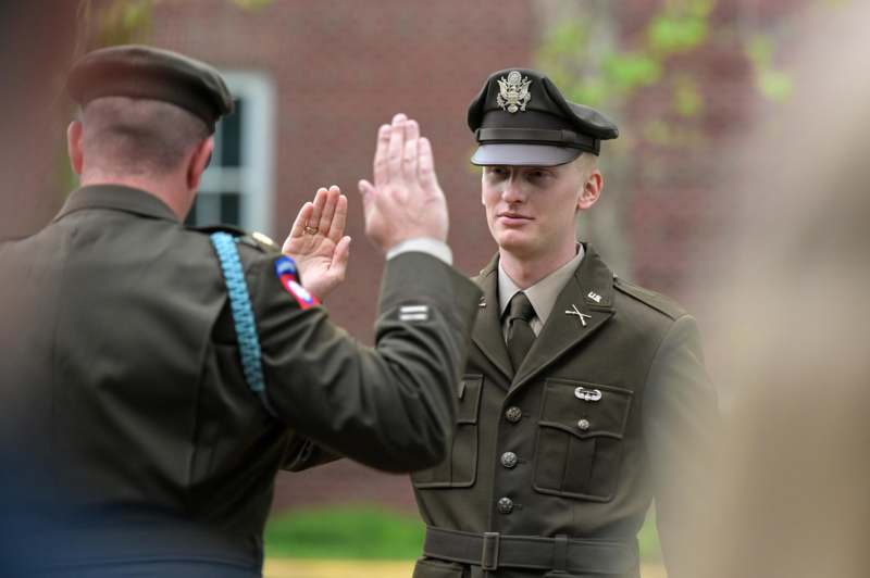 a man in uniform giving a high five to another man