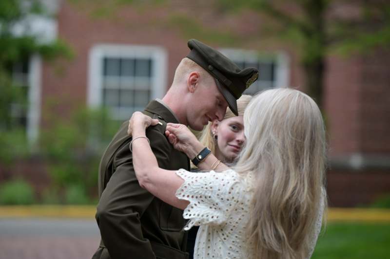 a woman hugging a man in a military uniform