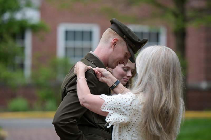 a woman in a white dress and a man in a uniform