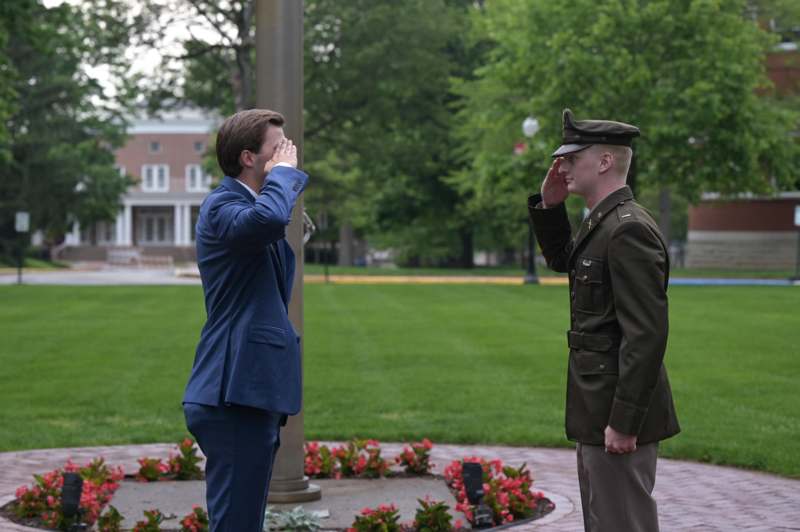 a man saluting another man in uniform