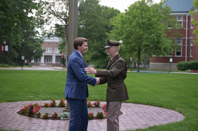 two men shaking hands outside