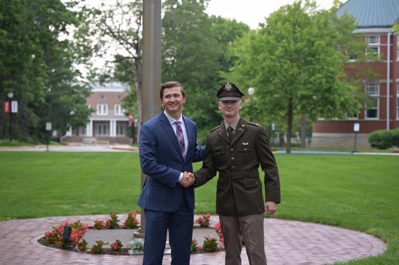 two men in suits shaking hands
