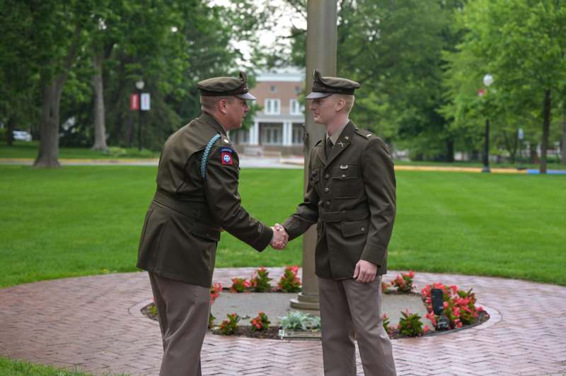 two men in military uniforms shaking hands