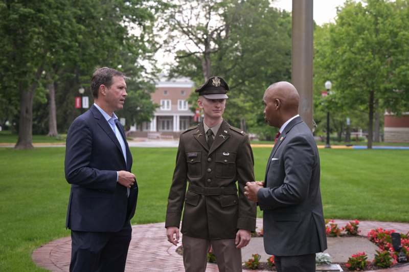 a group of men in suits talking to each other