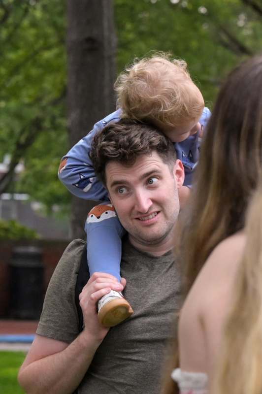 a man carrying a child on his shoulders