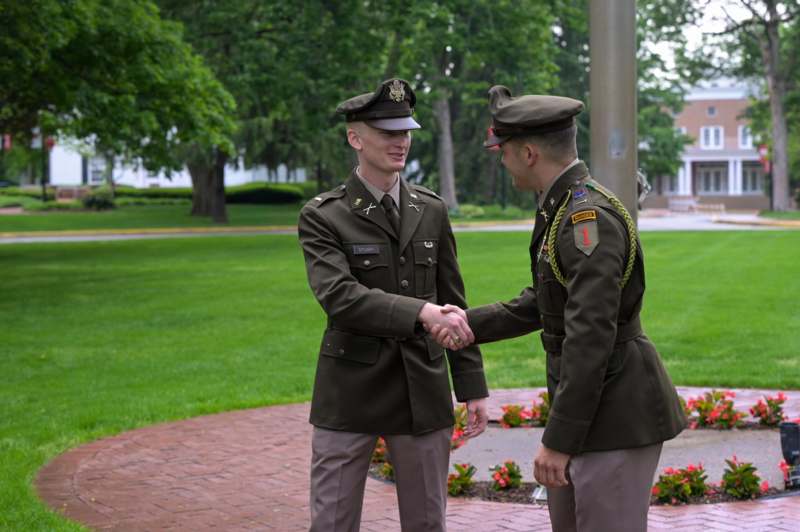 two men in military uniforms shaking hands