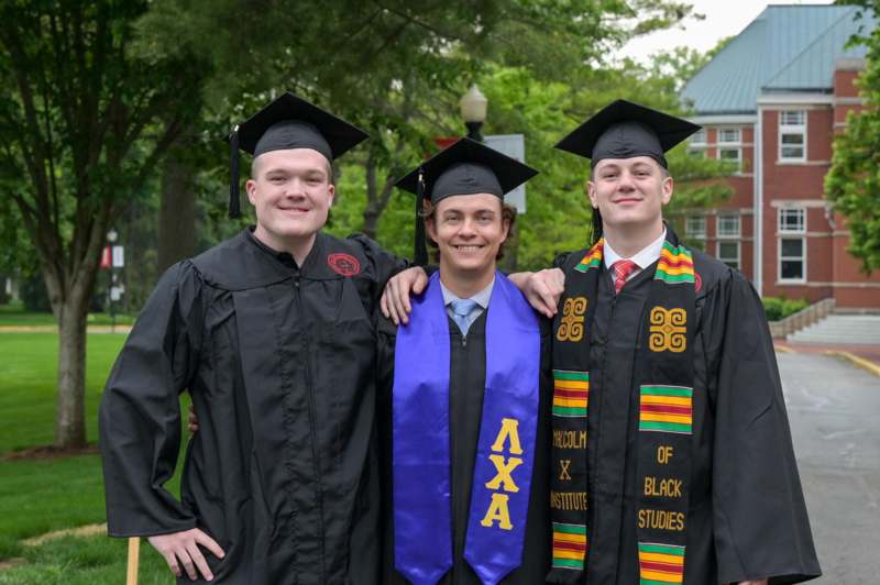a group of men in graduation gowns and caps