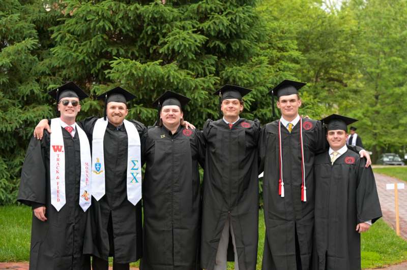 a group of people in graduation gowns and caps