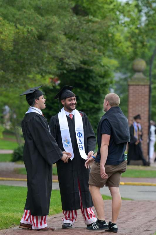 a group of men in graduation gowns and caps