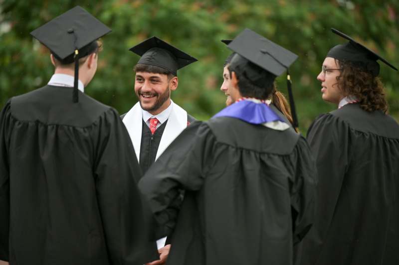a group of people in graduation gowns and caps