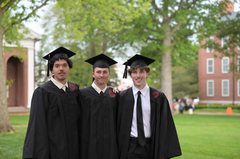 a group of men in graduation gowns and caps