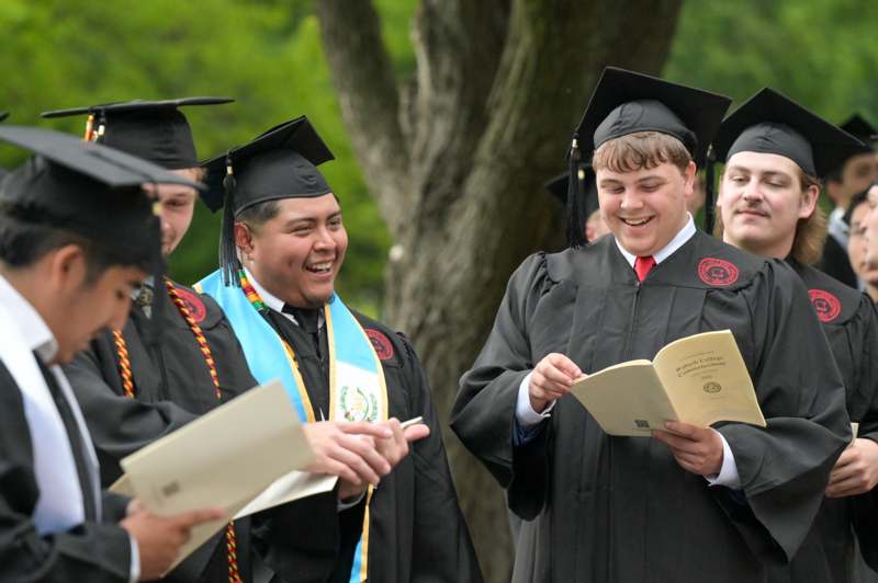 a group of people in graduation gowns and caps