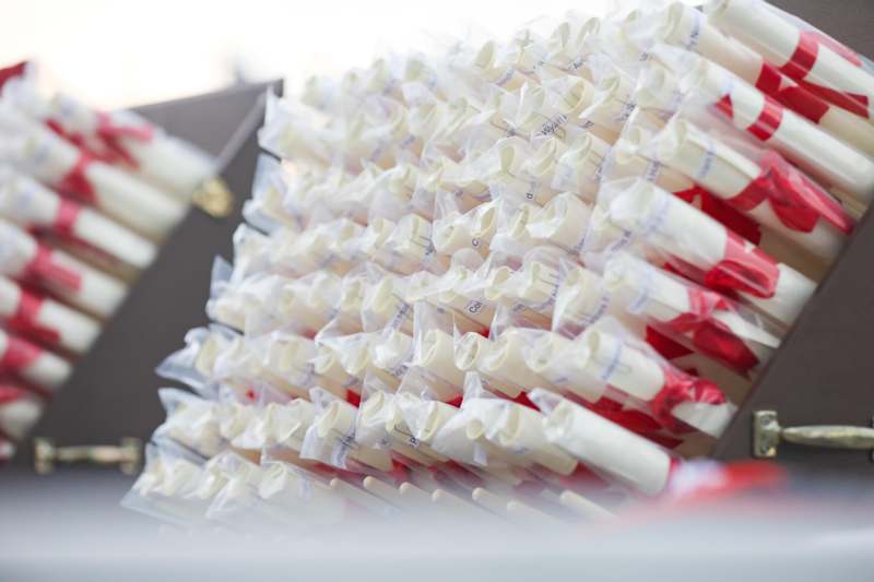 a group of white and red rolled up paper rolls